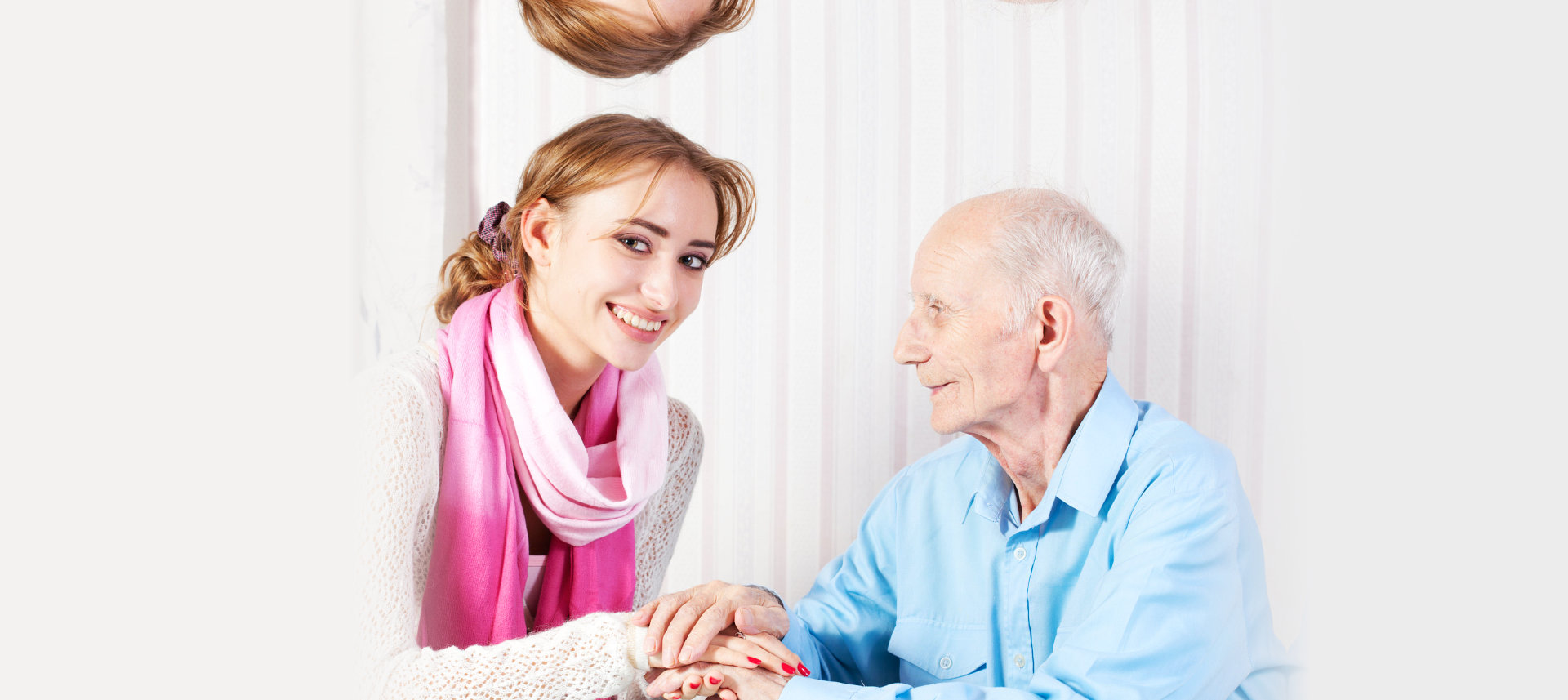 caregiver holding the hands of an elder